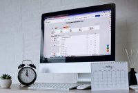 viewer following live US economy news with laptop market charts and economic calendar notes